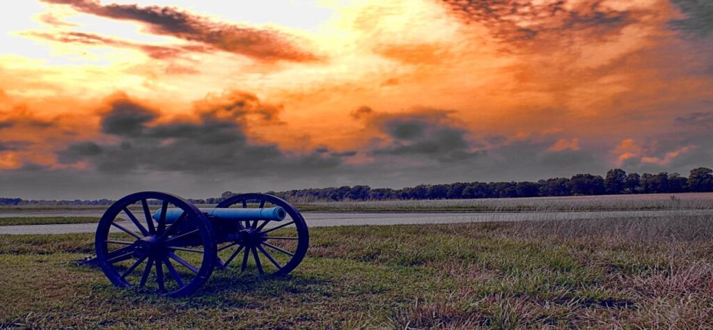 Cannon at sunset on a civil war battlefield
