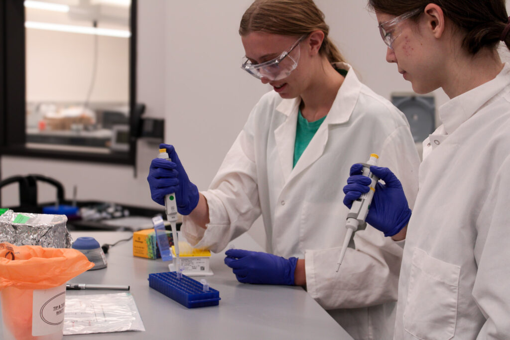 High school interns Tessara Clark and Evelyn Zadzilka work in the lab during their Maydm internships in Promega R&D