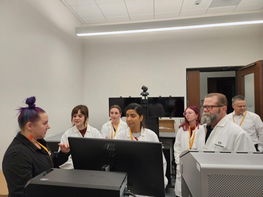 Val Watts and his students test the GloMax Galaxy Bioluminescence Imager at Promega Madison.